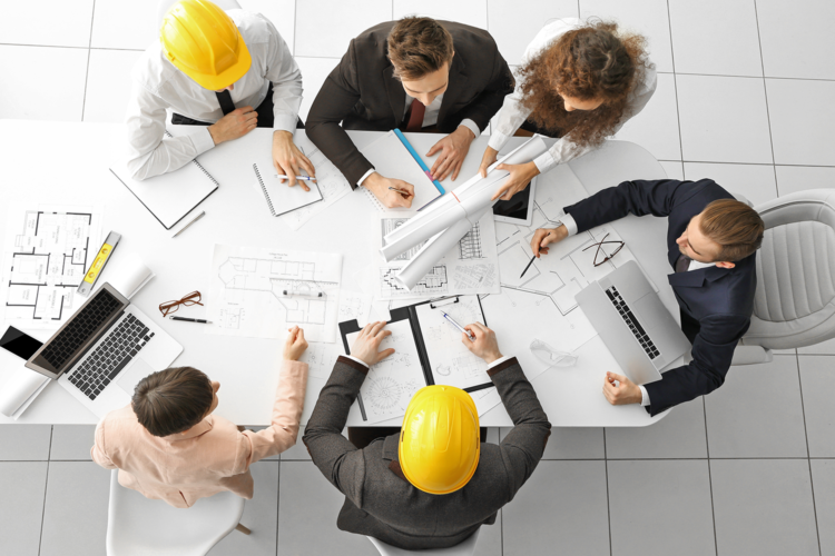 Nelson-and-Company-Engineers-Working-on-HVAC-Plans-Around-Office-Table